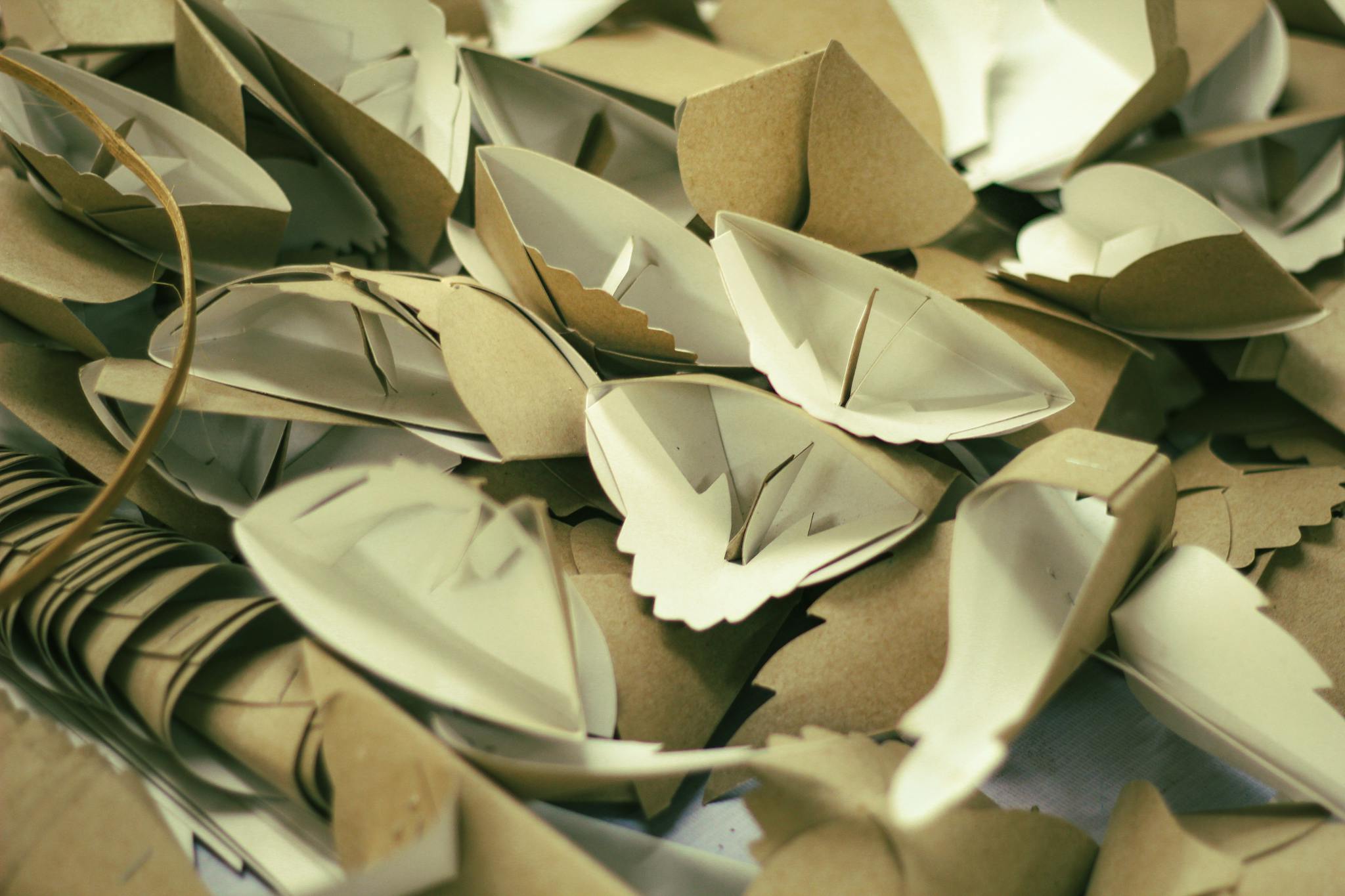 A close-up shot of several paper origami boats showcasing intricate folding and artistic design.